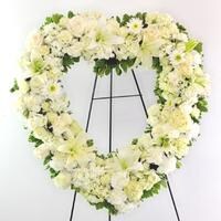 An all white fresh flower heart shaped wreath.